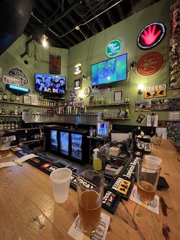 Denver bar counter with drinks and a Topo Chico neon sign